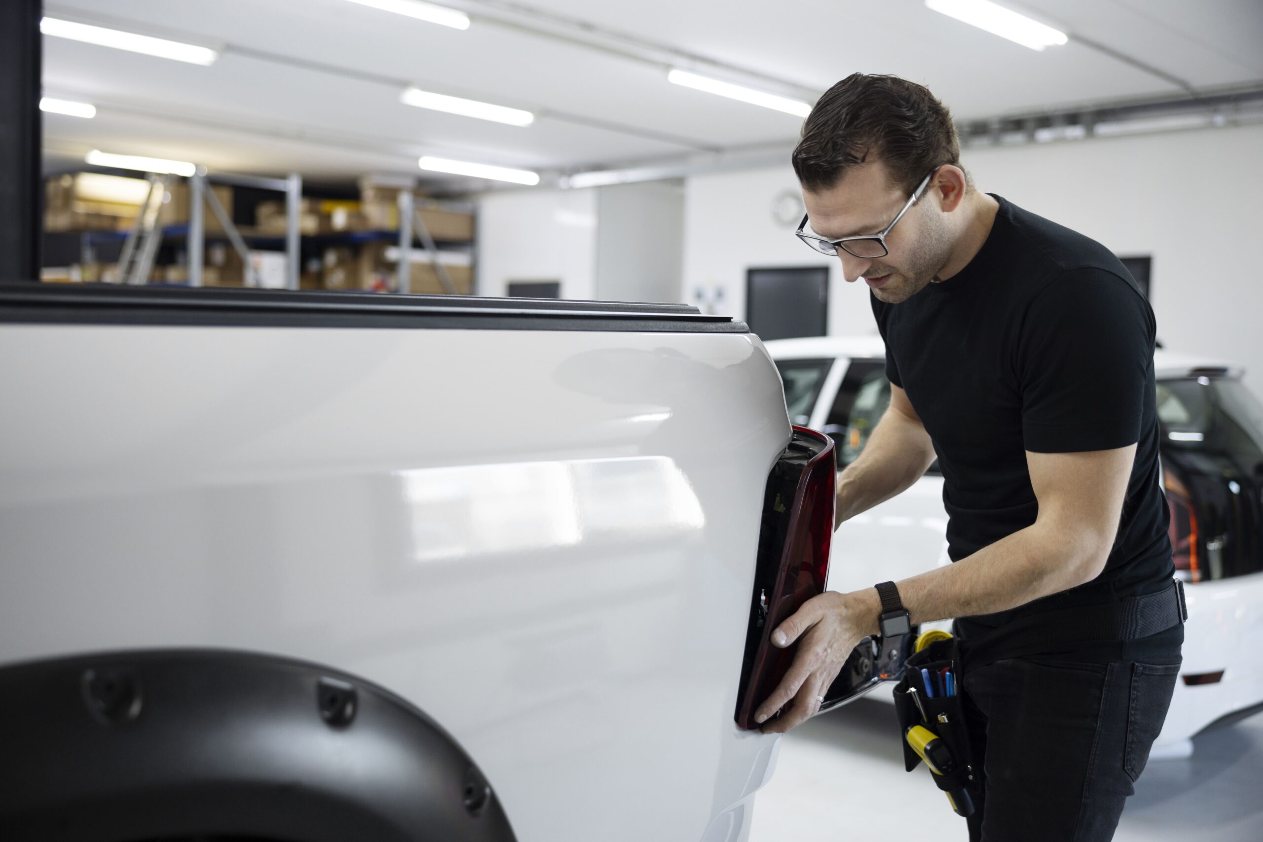 medium-shot-man-fixing-car-min